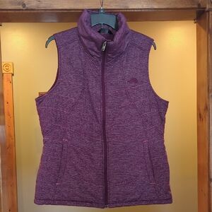  The North Face Women's Pseudio Puffer Vest in a quilted purple heather pattern.